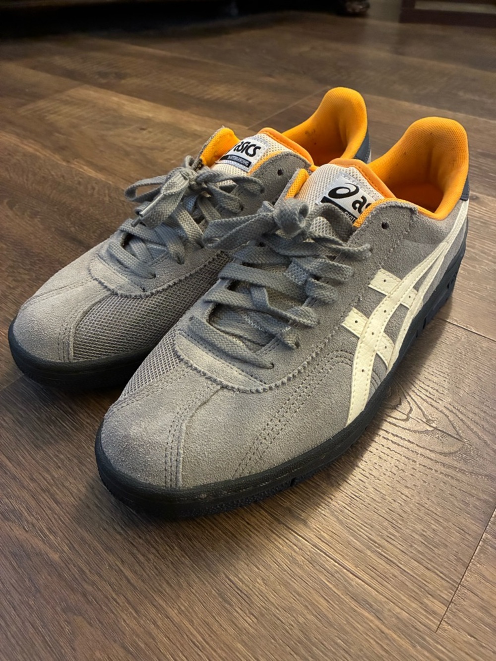 ASICS Gray Suede Sneakers with White Stripes and Orange Lining
